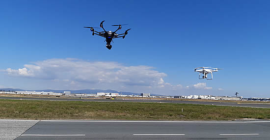 A swarm of drones (Yuneec and DJI) takes off from the apron at Frankfurt Airport